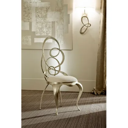 Design chair with swirls, iron structure, and Cantori upholstered seat.